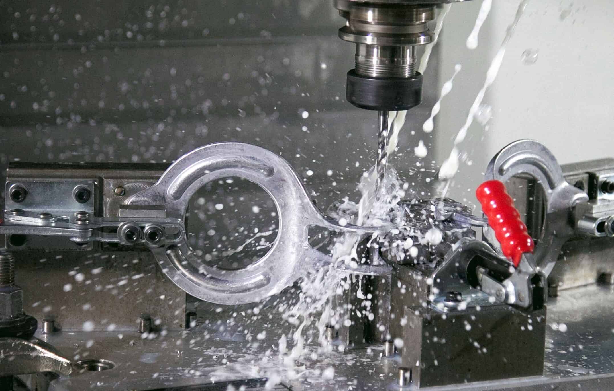 CNC machining of a metal component with coolant spray for precision.